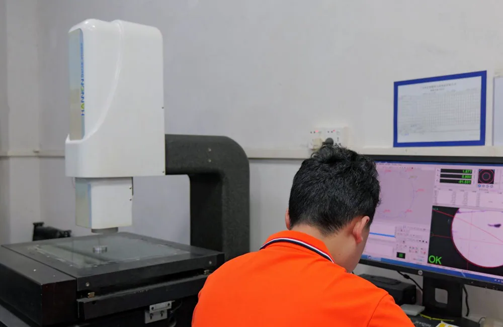 VOGUC technician using 2.5D vision measurement equipment